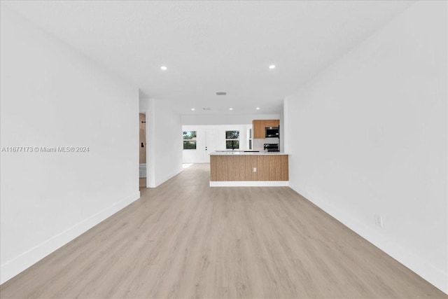 unfurnished living room with light hardwood / wood-style flooring