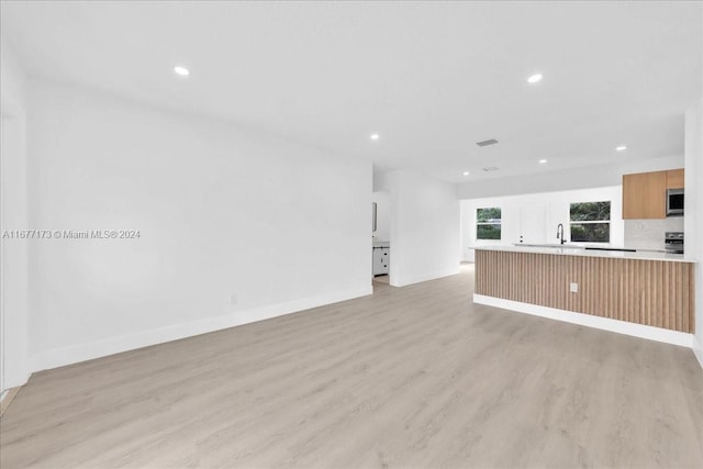 unfurnished living room featuring light wood-type flooring