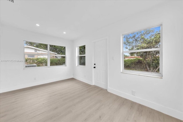 spare room with light hardwood / wood-style floors