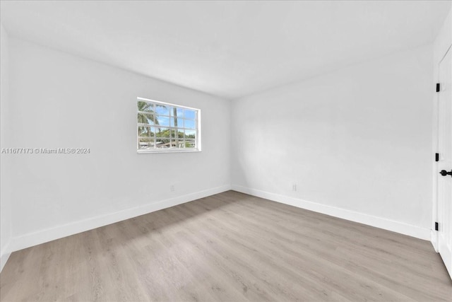 empty room with light hardwood / wood-style flooring