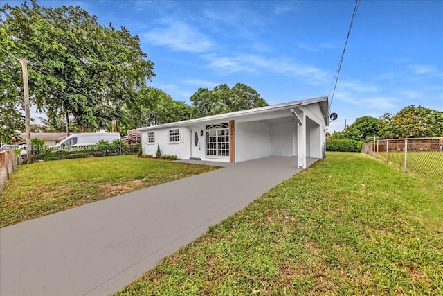 view of front of house with a front lawn and a carport