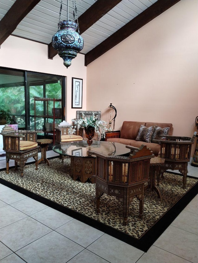 tiled living room featuring lofted ceiling and an inviting chandelier