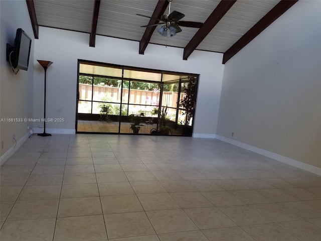 tiled empty room featuring ceiling fan, beam ceiling, and a high ceiling