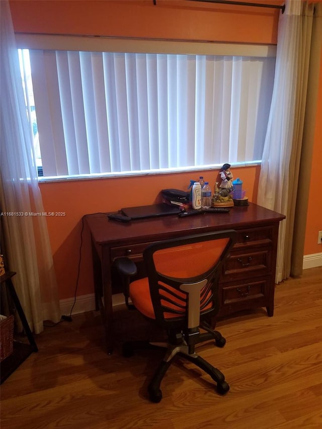 office space with wood-type flooring