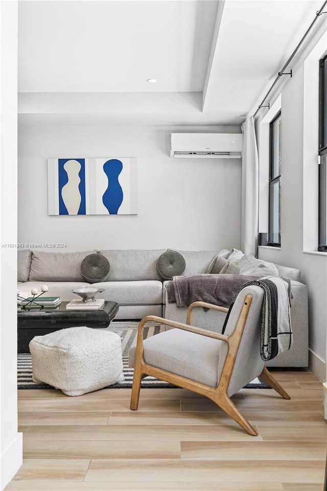 living room featuring hardwood / wood-style floors and a wall mounted air conditioner