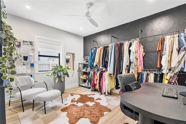 walk in closet featuring ceiling fan and light hardwood / wood-style floors