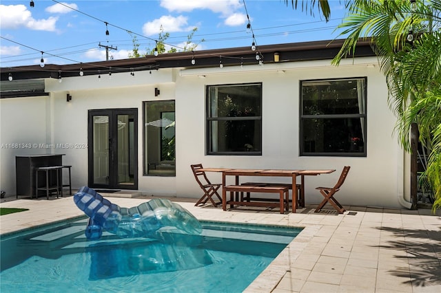 back of house with french doors and a patio