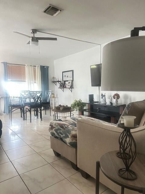 tiled living room featuring ceiling fan