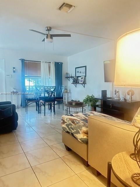 living room featuring light tile patterned flooring and ceiling fan