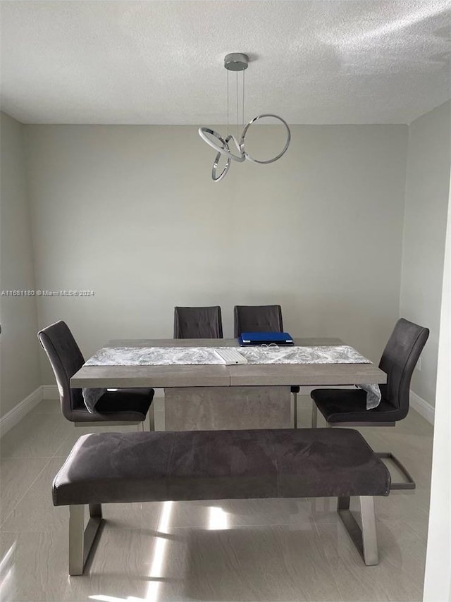 dining space featuring a textured ceiling