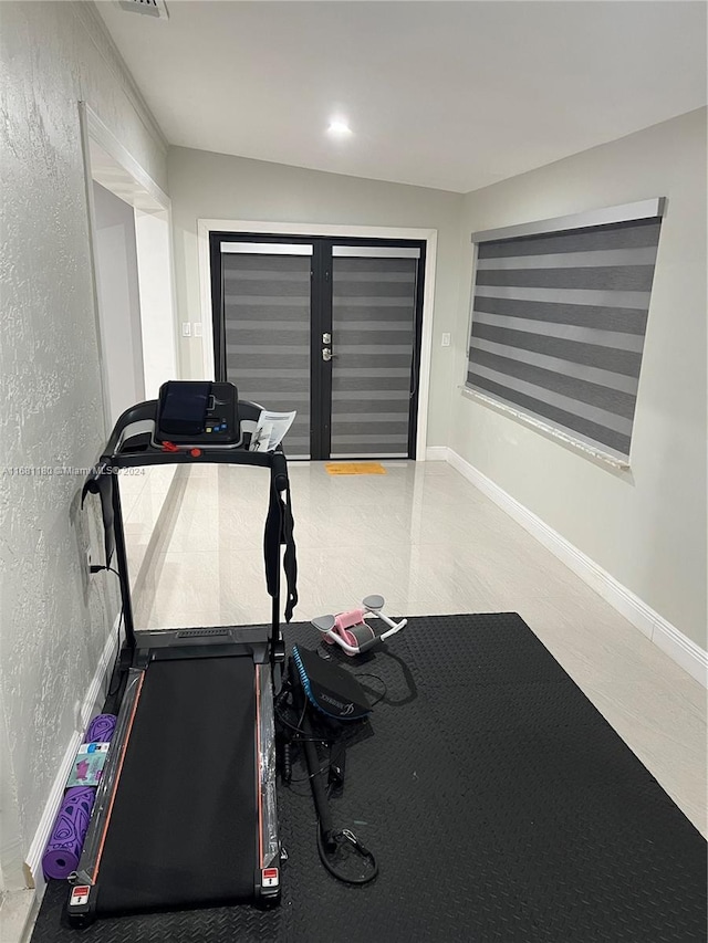 workout room featuring lofted ceiling