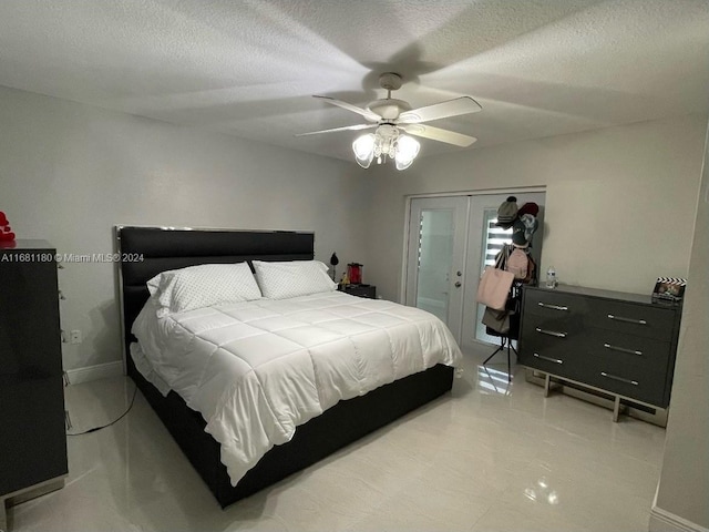 bedroom with french doors, ceiling fan, and a textured ceiling