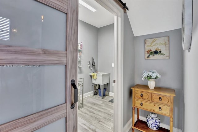 interior space featuring hardwood / wood-style flooring and a barn door