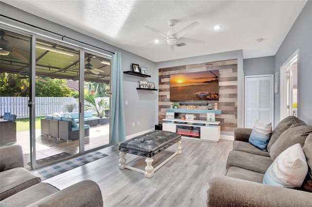 living room featuring light wood-type flooring and ceiling fan