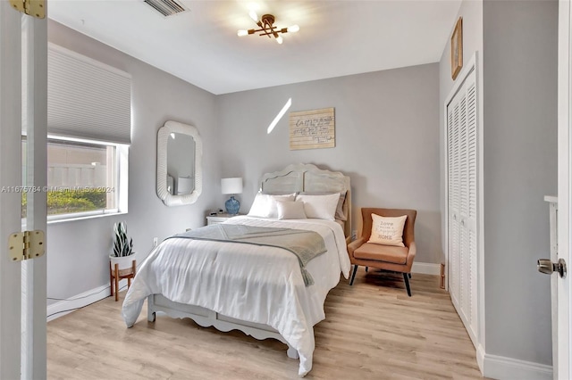 bedroom with a closet and light hardwood / wood-style floors