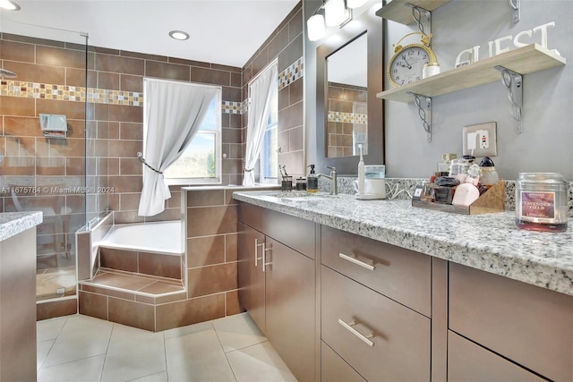 bathroom featuring vanity, tile walls, separate shower and tub, and tile patterned flooring