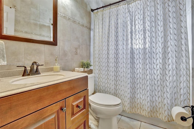 bathroom with toilet, tile patterned flooring, vanity, a shower with shower curtain, and tile walls