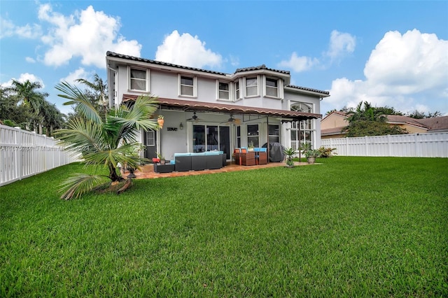 back of property featuring a yard, ceiling fan, a patio area, and outdoor lounge area