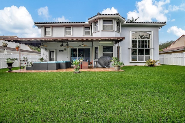 rear view of house with a patio, ceiling fan, a yard, and outdoor lounge area