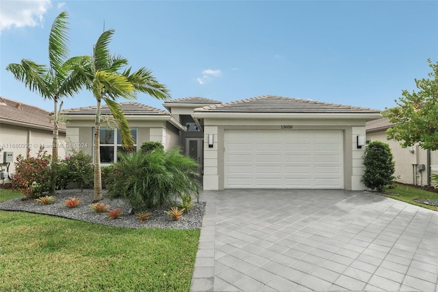 view of front facade with a garage and a front lawn