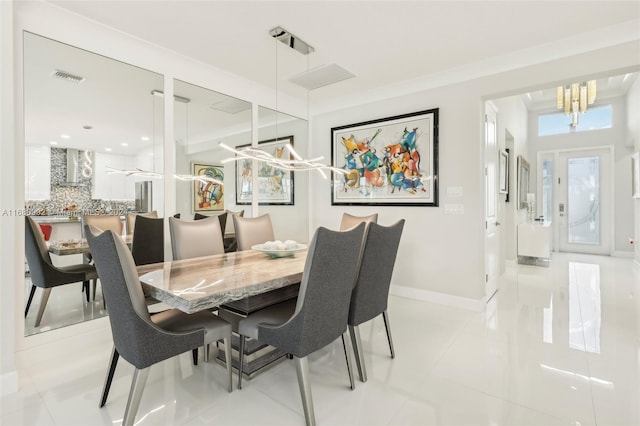 dining space with a notable chandelier and light tile patterned floors