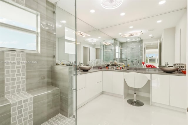 bathroom featuring vanity and a shower with door