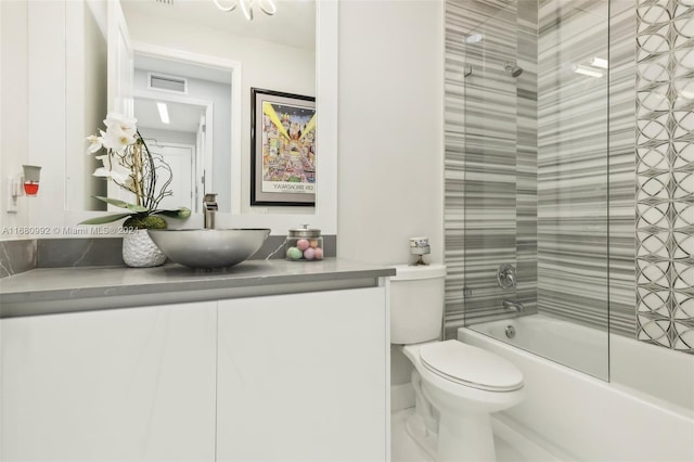 full bathroom featuring toilet, tiled shower / bath combo, and vanity