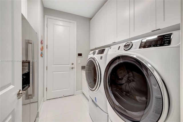 washroom featuring cabinets, separate washer and dryer, and light tile patterned floors