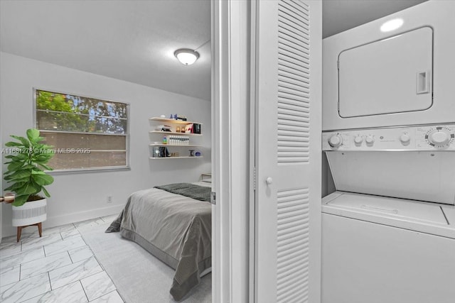 bedroom featuring stacked washer and dryer