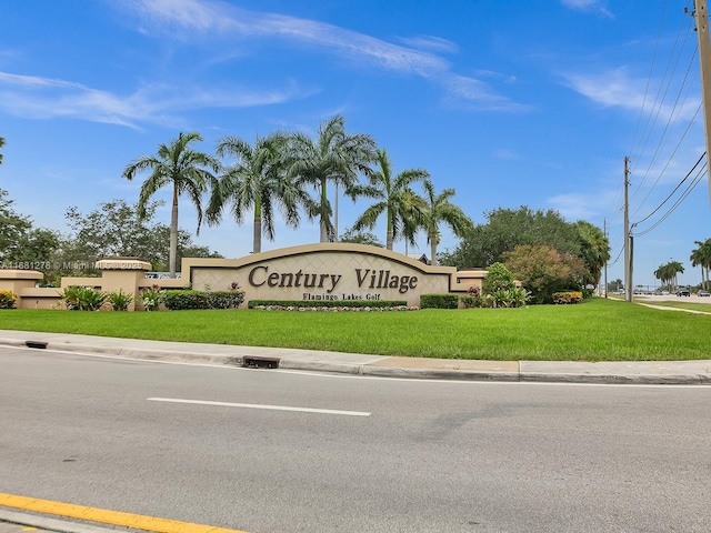 community / neighborhood sign with a lawn