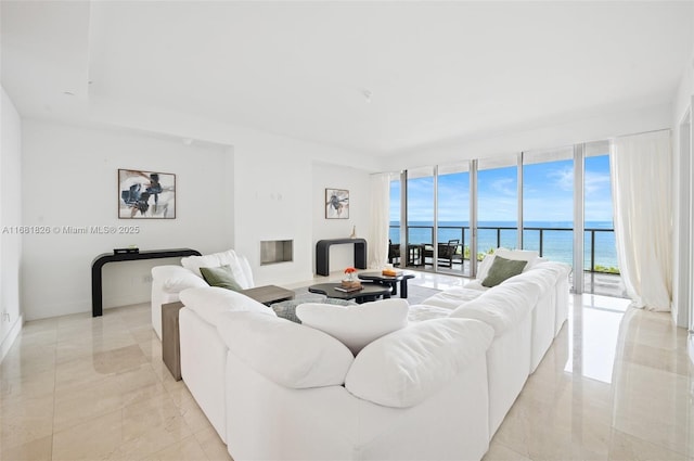 living area featuring a water view and expansive windows