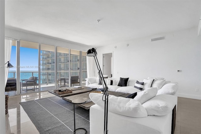 living room with a water view and concrete floors