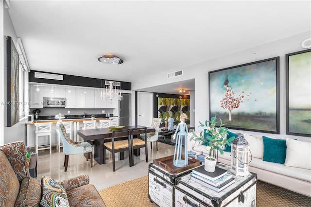 tiled living room featuring a chandelier