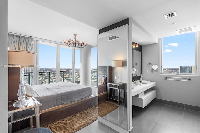 tiled bedroom featuring multiple windows and an inviting chandelier