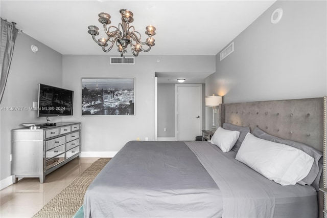 bedroom featuring a notable chandelier and light tile patterned flooring