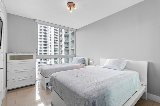 tiled bedroom featuring multiple windows