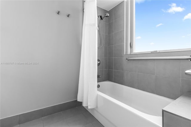 bathroom with shower / tub combo with curtain and tile patterned floors