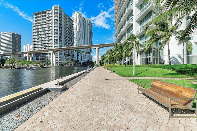 view of home's community featuring a water view and a lawn