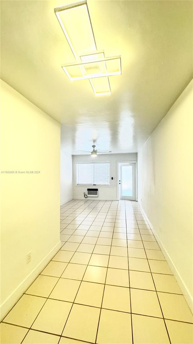 unfurnished living room featuring light tile patterned floors and ceiling fan