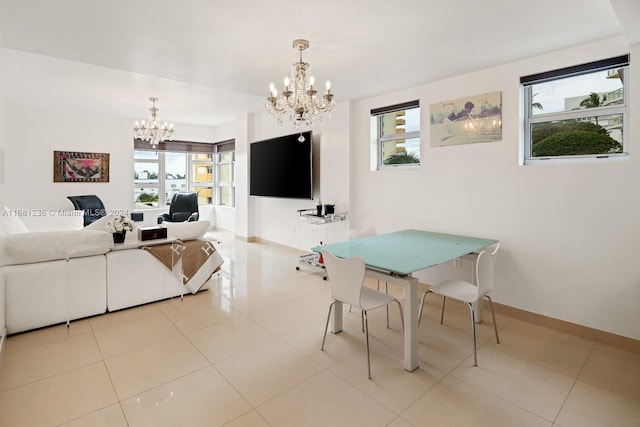 dining room featuring a notable chandelier and light tile patterned flooring