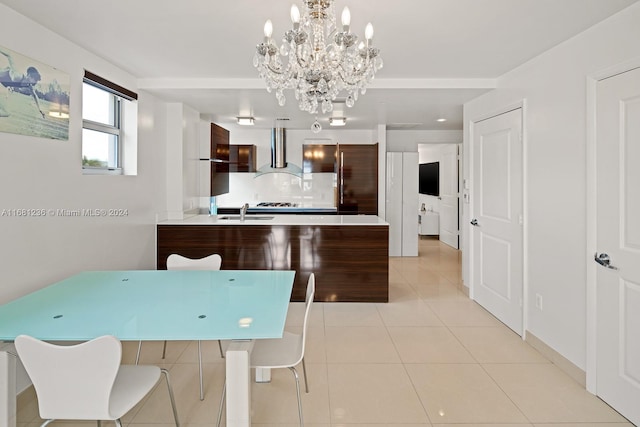 dining area with light tile patterned floors, sink, and an inviting chandelier