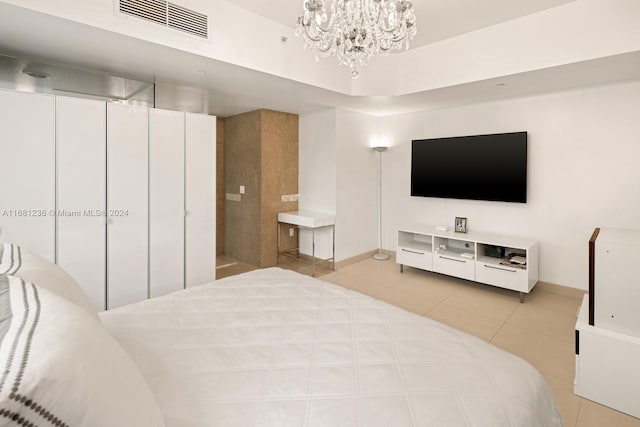 tiled bedroom featuring a closet and a chandelier