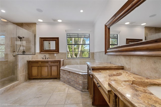 bathroom featuring vanity, ornamental molding, and shower with separate bathtub