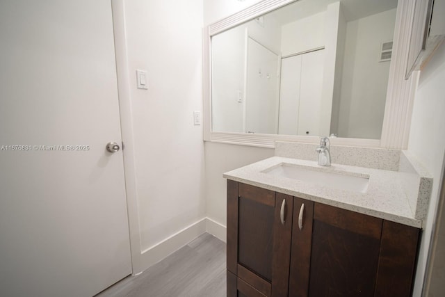 bathroom featuring hardwood / wood-style flooring and vanity