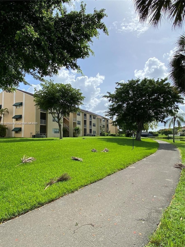 view of home's community with a yard