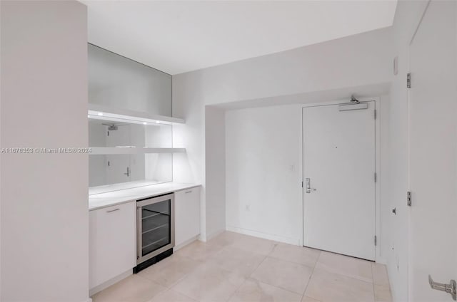 kitchen featuring wine cooler and light tile patterned floors