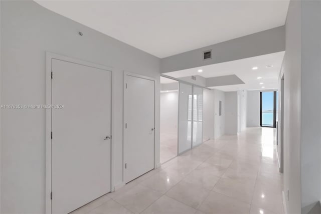 hallway featuring light tile patterned flooring