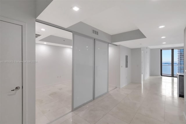 hallway featuring expansive windows and a water view