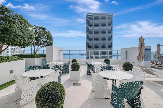 view of patio / terrace featuring a balcony and a water view