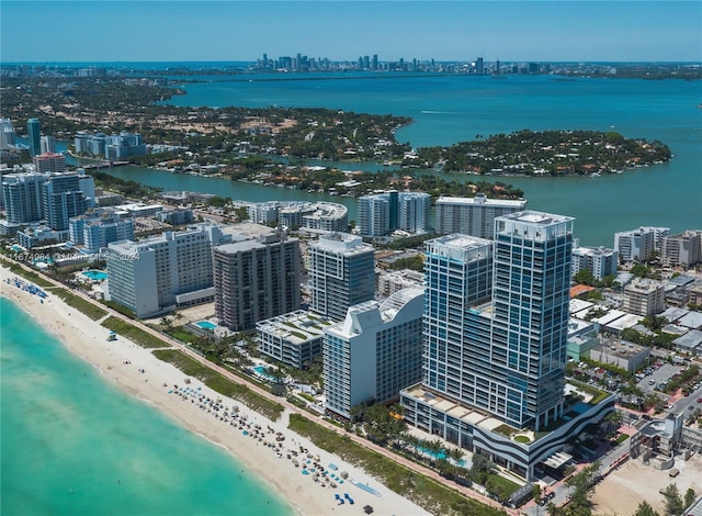 drone / aerial view with a water view and a beach view